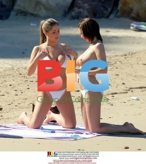 Glamour models relax on beach in France