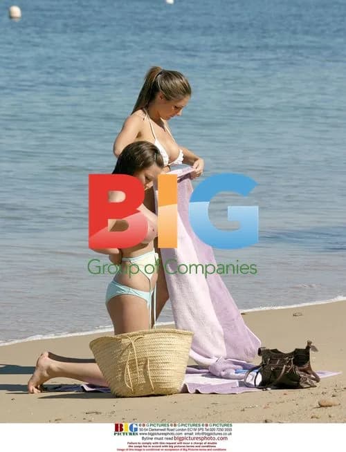 Glamour models relaxing on beach in France