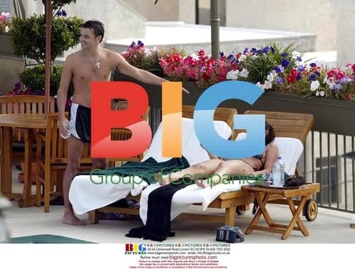 Michelle Heaton and boyfriend relax poolside