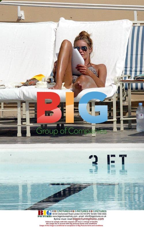 Elle Macpherson Relaxing by Pool