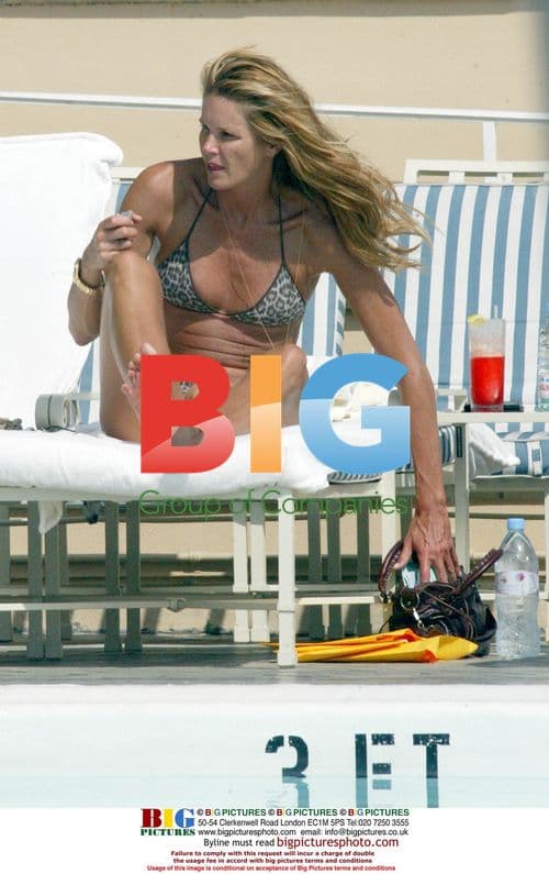 Elle Macpherson Relaxing by Pool in Beverly Hills