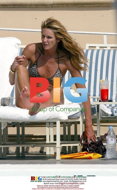 Elle Macpherson Relaxing by Pool