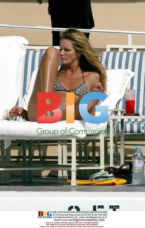 Elle Macpherson Relaxing by Pool