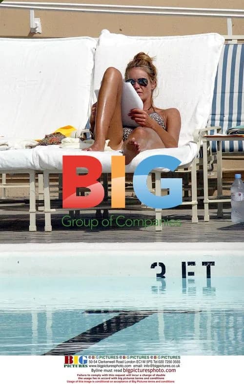 Elle Macpherson Relaxing by Pool