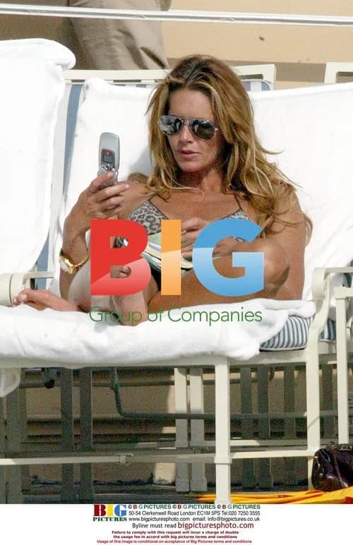 Elle Macpherson Relaxing by Pool