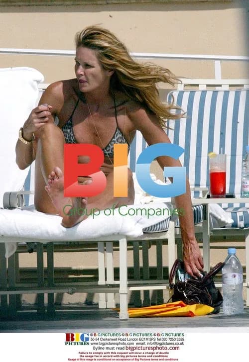 Elle Macpherson relaxing poolside
