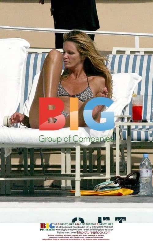 Elle Macpherson Relaxing by Pool