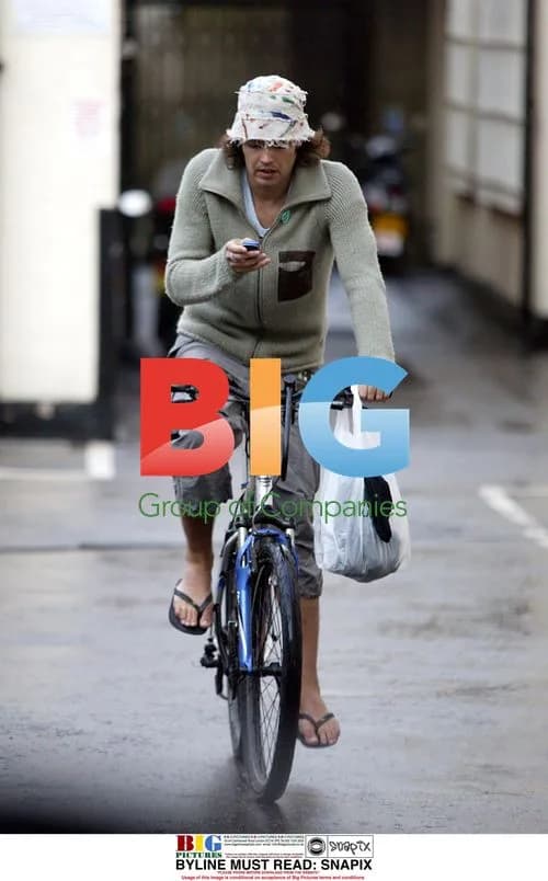 Russell Brand riding bike in London
