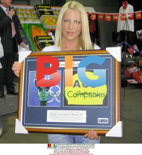 Melissa Tkautz Holds Grant Hackett's Swim Cap