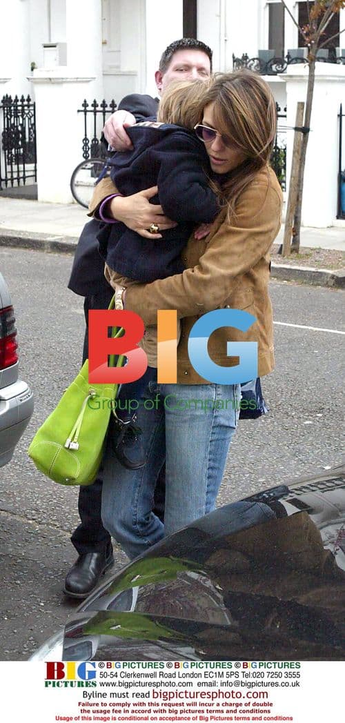 Liz Hurley arrives home with son and fiance