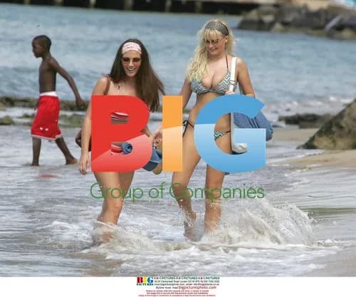 Glamour models Michelle Marsh and Lucy Pinder on beach in St. Lucia
