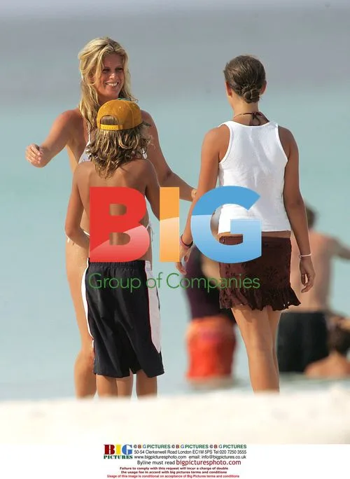 Rachel Hunter with children on beach after SI shoot