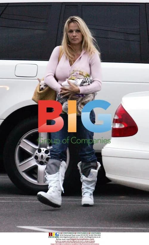 Pamela Anderson Carrying Puppy in Malibu