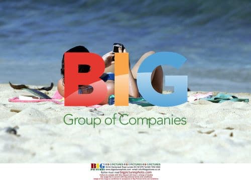 Evangeline Lilly Sunbathes on the Beach