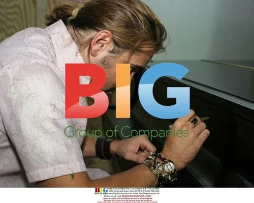 Colin Farrell Signs Piano for Hurricane Katrina