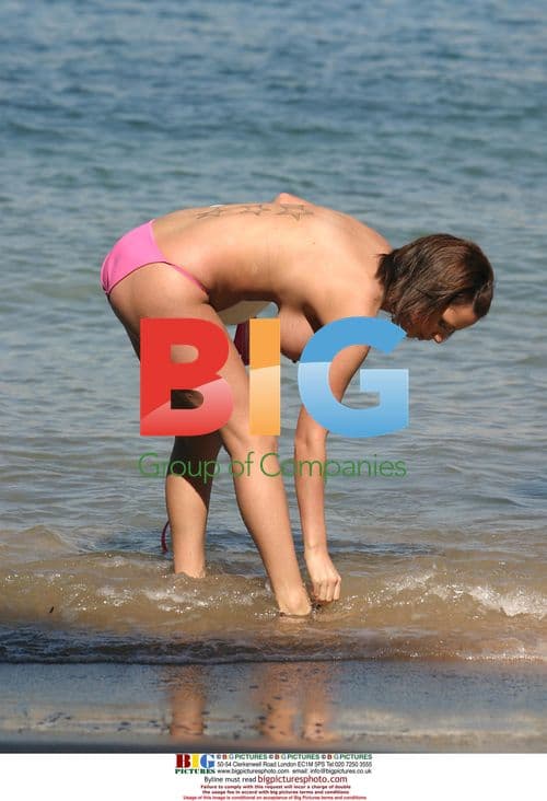 Glamour models Lucy Pinder and Sophie Howard play in the sea