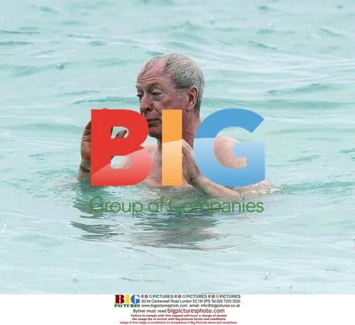 Michael Caine takes stroll on Barbados beach