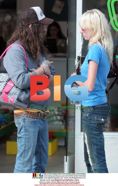 Kimberly Stewart and Cisco Adler play with chihuahua pup