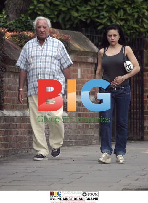 Michael Winner and Dining Partner Paola Strolling in North London