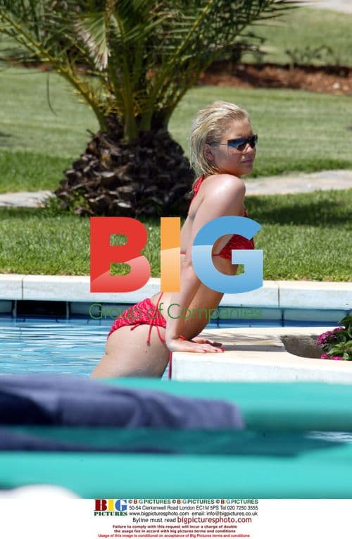 Singer Suzanne Shaw Sunbathes by Pool
