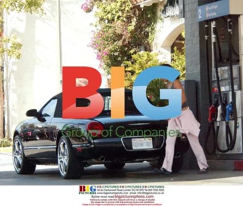 Halle Berry Pumps Gas in Pink Tracksuit