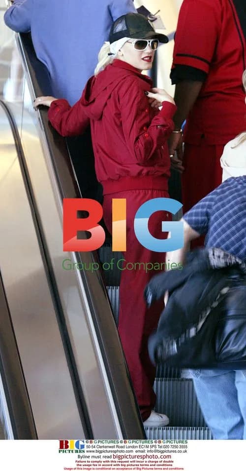 Gwen Stefani in Red Tracksuit With Bodyguard at LAX