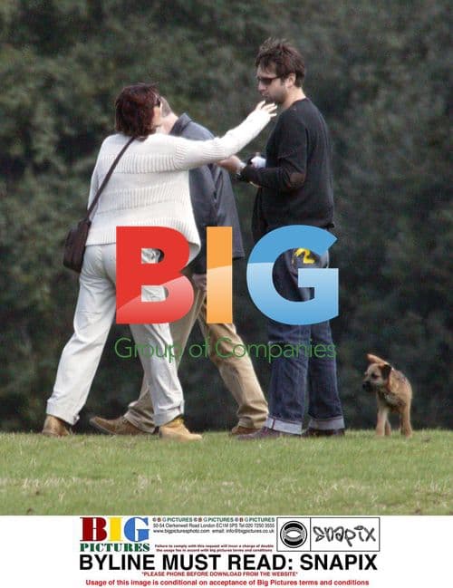 Sarah Parish and boyfriend cuddle in park
