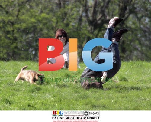 Sarah Parish and boyfriend canoodling in park