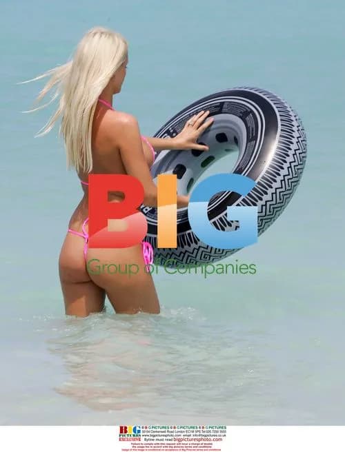 Model Emma B plays in the sea