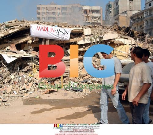 Residents of Beirut pass bombed-out building