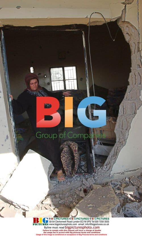 Woman returns to destroyed home in Srifa, Lebanon