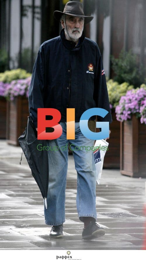 Christopher Lee walks in North London rain