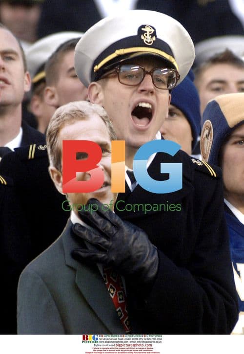 Midshipman Holds Cutout of Bush at Army Navy Game