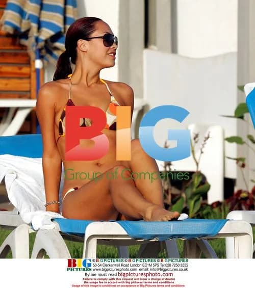 Myleene Klass relaxes by pool in Caribbean