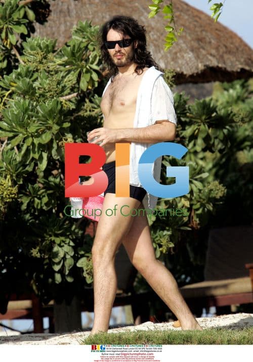 Russell Brand and mystery lady on beach