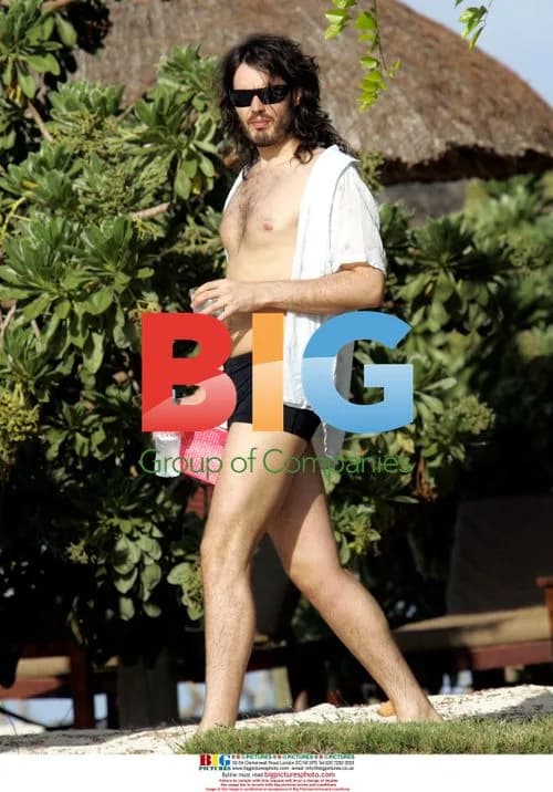 Russell Brand and mystery lady on beach