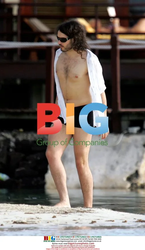 Russell Brand and mystery lady on beach