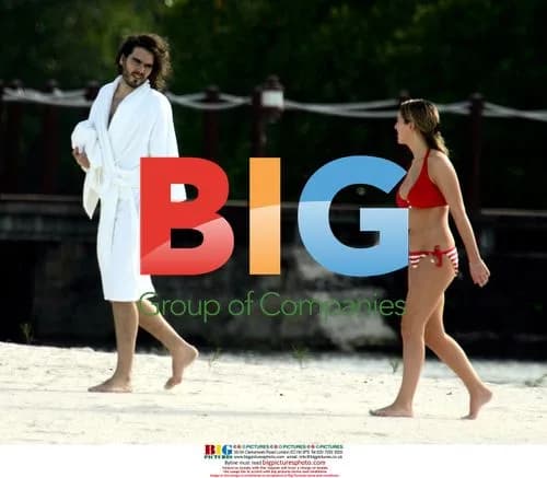 Russell Brand and mystery lady on beach