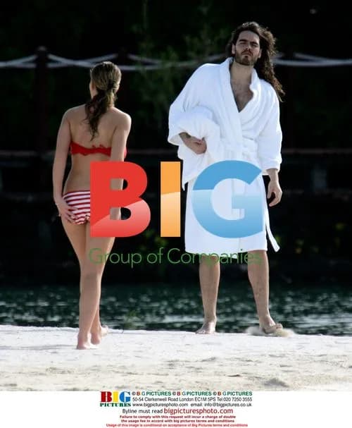 Russell Brand and mystery lady on beach