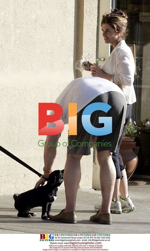 Arnold Schwarzenegger and Maria Shriver play with puppy