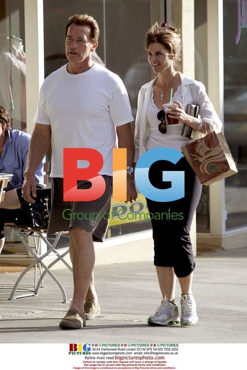 Schwarzenegger and Shriver play with puppy