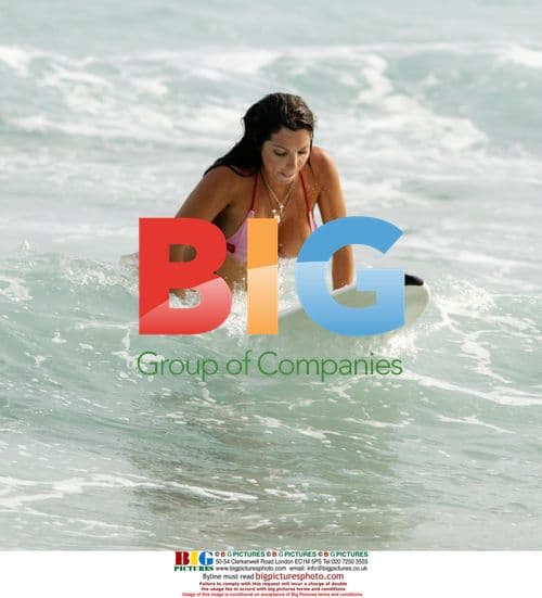 Glamour model Coralie surfing in the Caribbean