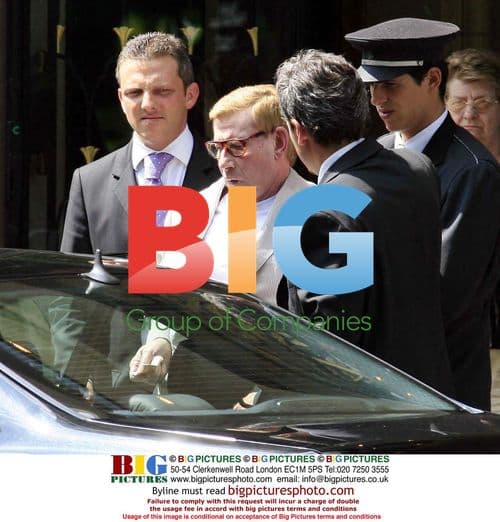 Yves Saint Laurent Assisted to Car