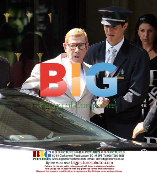 Yves Saint Laurent Assisted to Car at Hotel