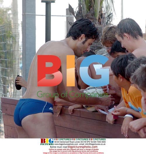 Fabio Grosso signing autographs on beach