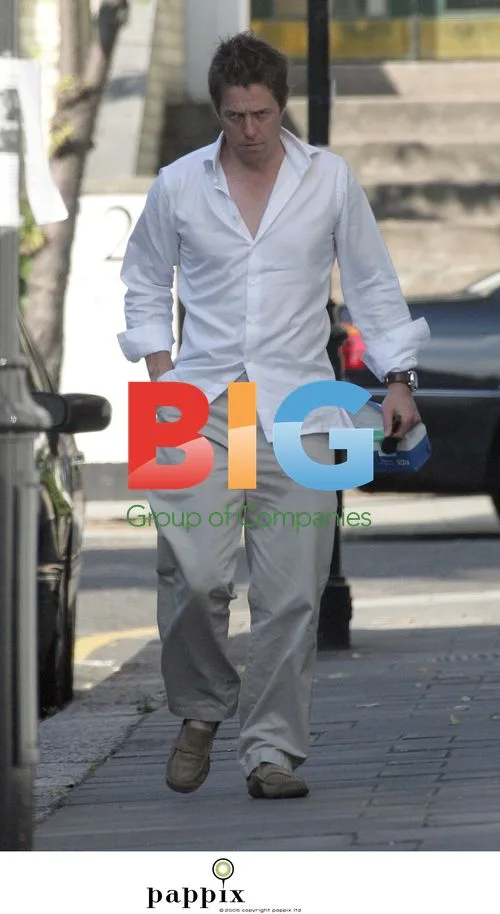 Hugh Grant arrives home with NHS prescription bag