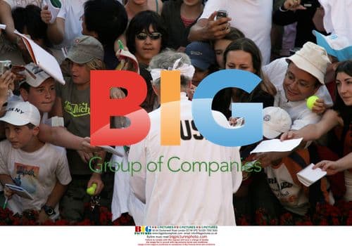 John Mcenroe signs autographs after French Open match