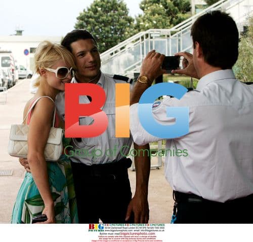 Paris Hilton poses with police at Cannes