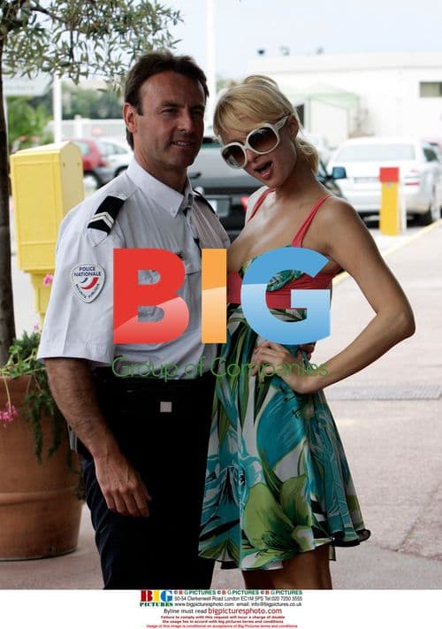 Paris Hilton poses with police at Cannes