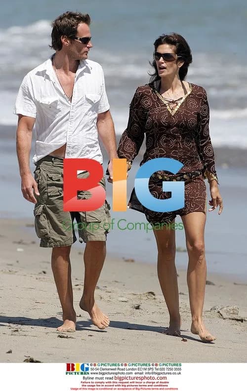 Cindy Crawford and Randy Gerber walk on Malibu beach